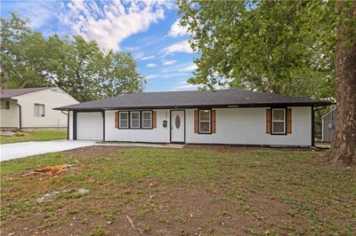 Ranch-style home with a front lawn and a garage | Image 1