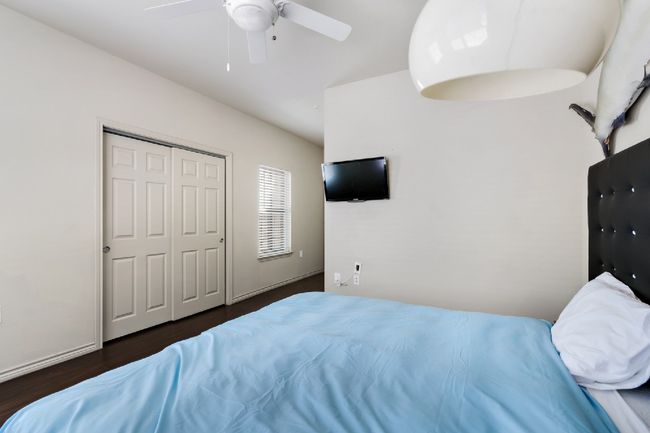Bedroom with wood finished floors, ceiling fan, and a closet | Image 20