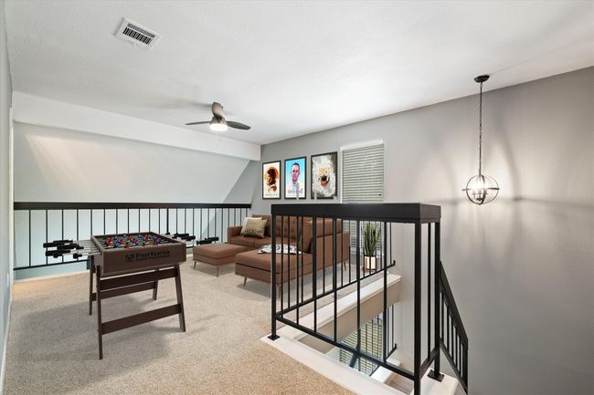 Playroom featuring a ceiling fan, carpet, and lofted ceiling | Image 5