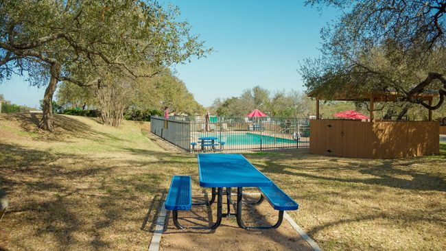 View of community featuring a yard, a pool, and fence | Image 5