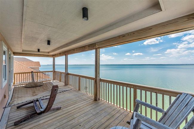 Connected to the upstairs bedrooms, enjoy endless water views on the covered balcony. You can catch the breeze, or just take in the view in peace. | Image 26