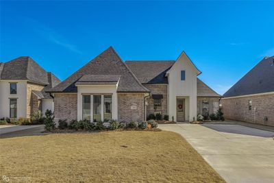 French country inspired facade featuring a front lawn | Image 2