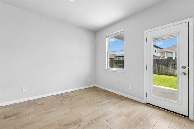 Spare room with light wood finished floors and healthy amount of natural light | Image 10