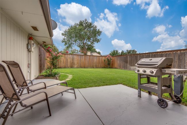 Fenced backyard with a patio area | Image 20