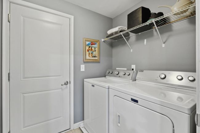 Just off the kitchen is the laundry room. This is a large room that was not fully captured. Behind the entry door is a floor to ceiling storage organizer | Image 31