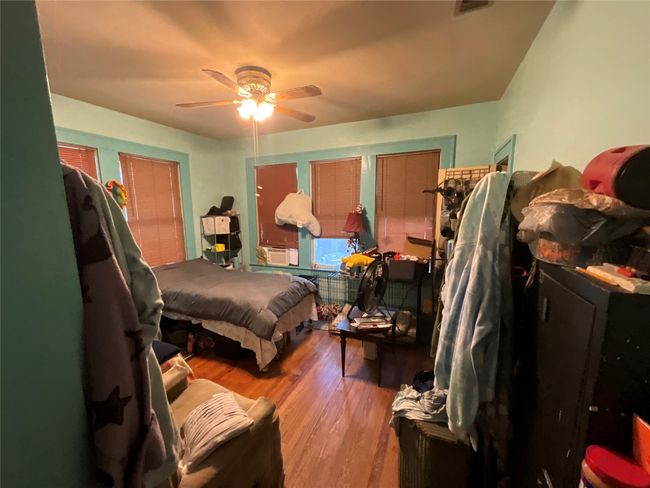 Bedroom with wood finished floors and a ceiling fan | Image 9