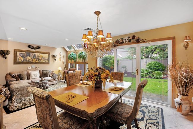 Dining space with light tile patterned floors, and recessed lighting | Image 8