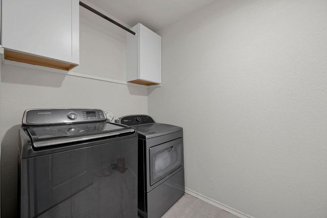 Laundry room with baseboards, washing machine and dryer, and cabinet space | Image 19