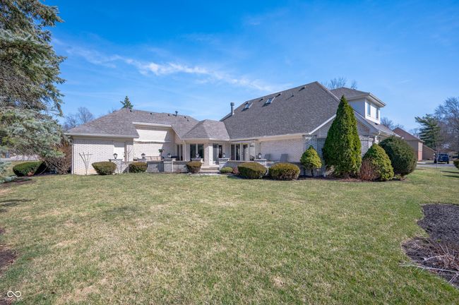 back of house featuring a patio, brick siding, a lawn, and a shingled roof | Image 36