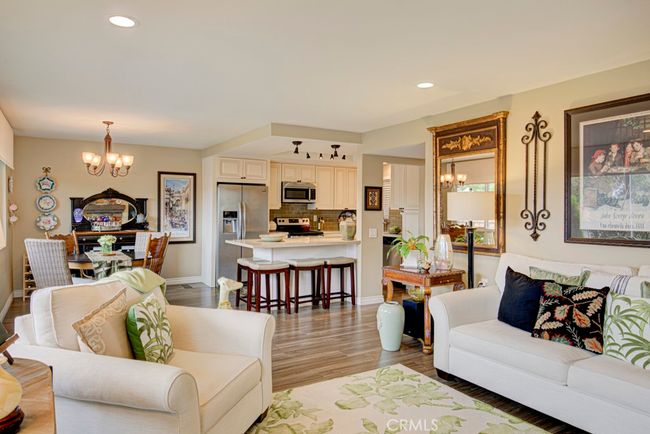View of dining area and kitchen from the living room. | Image 13
