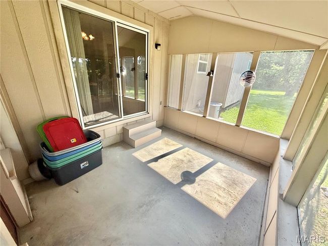 Unfurnished sunroom featuring vaulted ceiling and entry steps | Image 37
