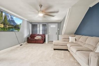 Carpeted living room with ceiling fan | Image 3