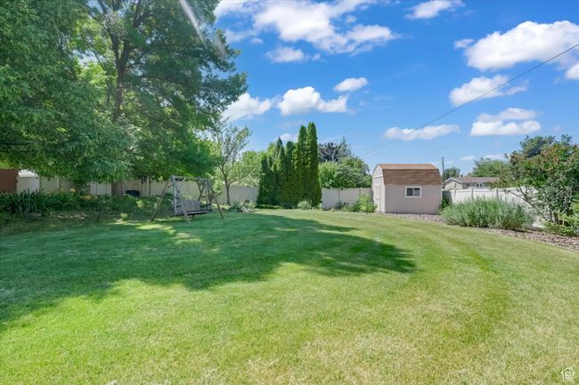 Fenced yard with a storage shed | Image 33