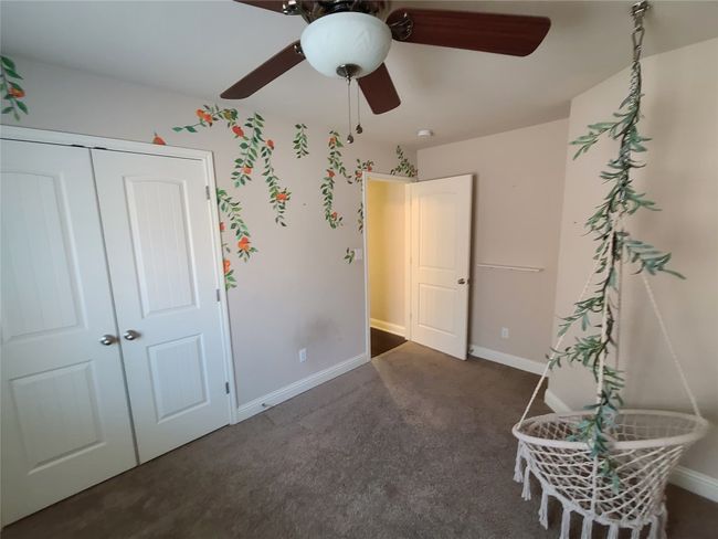 Carpeted bedroom featuring a closet and a ceiling fan | Image 27