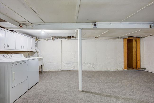 Unfinished below grade area with separate washer and dryer and light carpet | Image 39