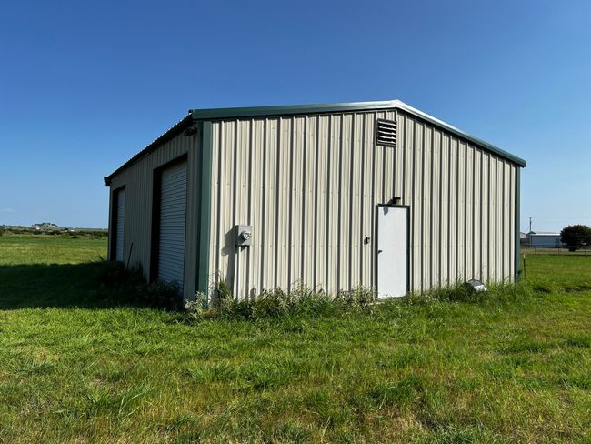 View of outdoor structure with an outbuilding | Image 24