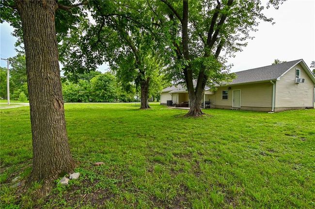View of grassy yard featuring a wall mounted AC | Image 36
