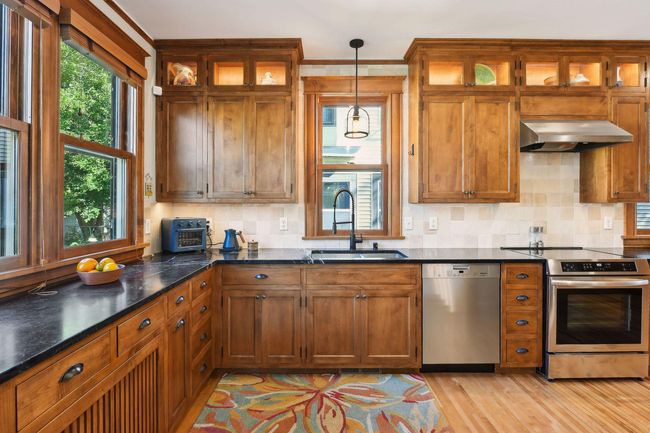 Maple kitchen cabinets with soft close birch drawers and soapstone counter tops. So much storage & workspace in this kitchen. | Image 5
