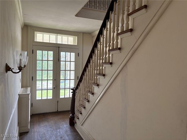 Foyer entrance with stairway and French doors to the covered porch | Image 4