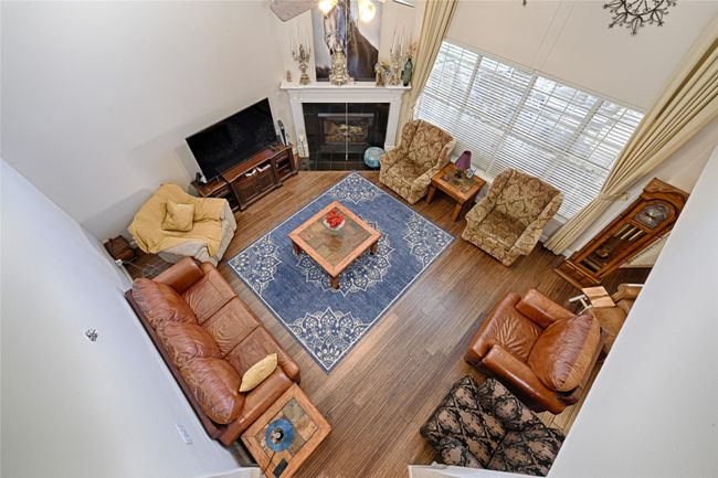 Living room with a tile fireplace and wood finished floors | Image 22