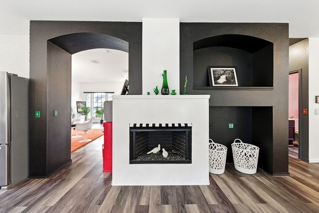 Living area with wood finished floors, ceiling fan, baseboards, and arched walkways | Image 13