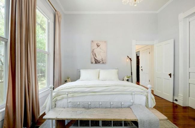 Bedroom featuring wood finished floors, crown molding, and a chandelier | Image 18