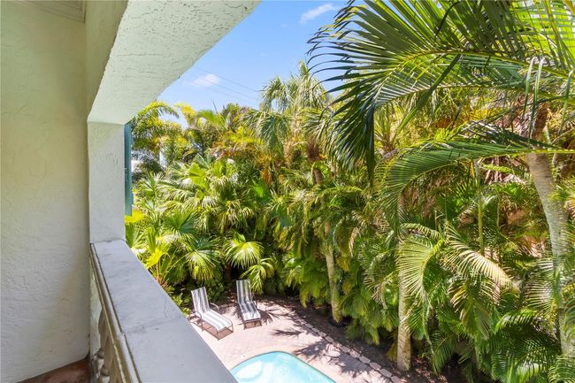 View of the pool from the covered lanai - lush landscaping gives plenty of privacy | Image 16