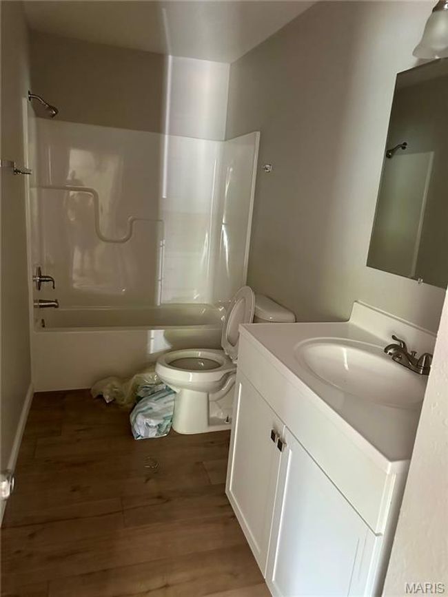 Bathroom with vanity, shower combination, and wood finished floors | Image 7