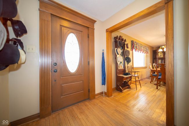 Entrance features Oval Beveled Glass & Wood Door. Hardwood floors in the foyer entrance. | Image 10