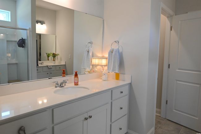 Full bathroom with a stall shower, vanity, and tile patterned floors | Image 19