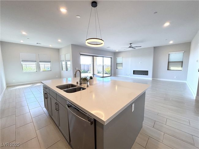 Kitchen featuring recessed lighting, a sink, baseboards, dishwasher, and open floor plan | Image 17