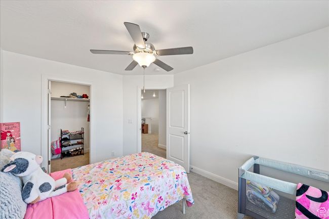 Bedroom with carpet floors, a ceiling fan, and a closet | Image 24