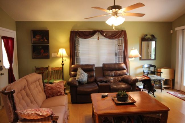 Living room featuring wood finished floors and ceiling fan | Image 10