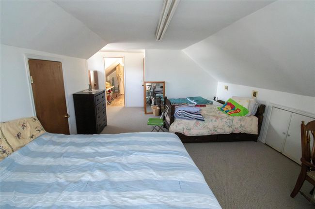 Carpeted bedroom with vaulted ceiling | Image 18