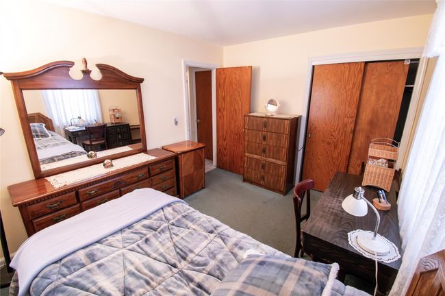 Bedroom with a closet and light carpet | Image 12