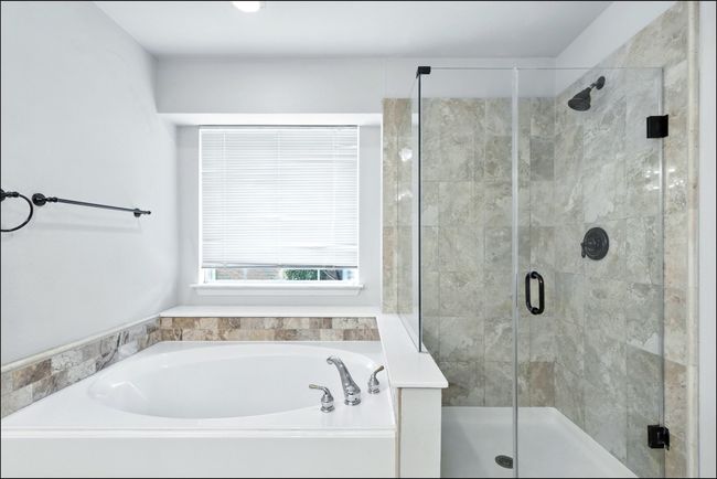 Bathroom featuring a garden tub and a stall shower | Image 33