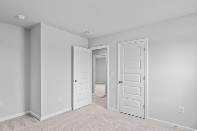 Unfurnished bedroom featuring baseboards, visible vents, and light colored carpet | Image 15