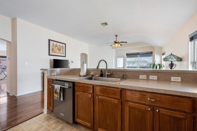 Kitchen featuring a sink, arched walkways, dishwasher, and ceiling fan | Image 20