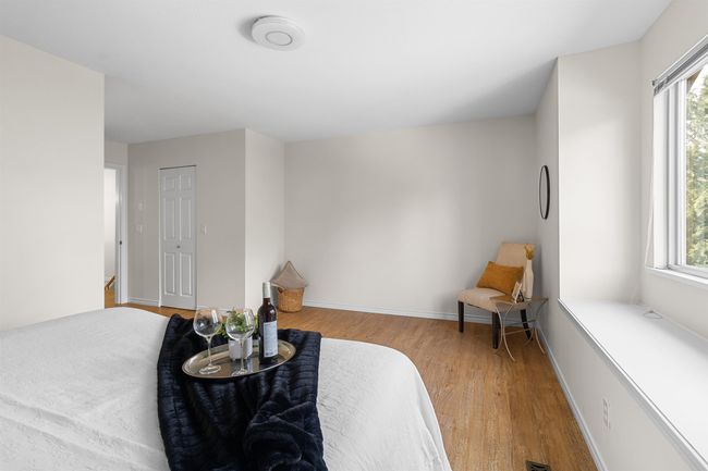Sitting room with wood finished floors and baseboards | Image 19