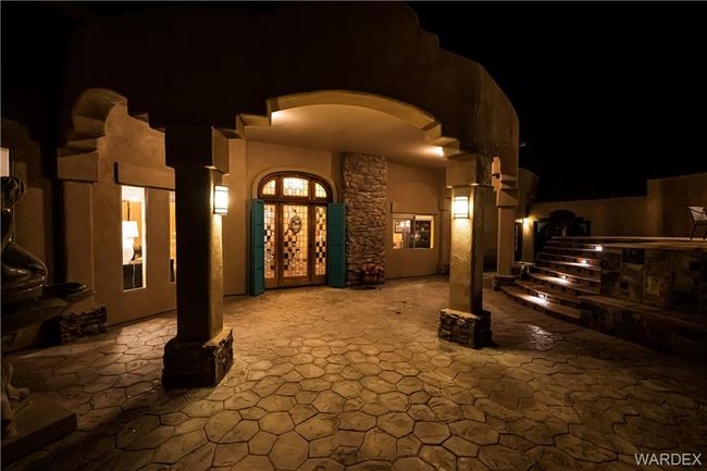 Exterior entry at night featuring a patio area | Image 17