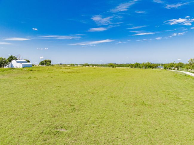 View of grassy yard with a view of countryside | Image 13