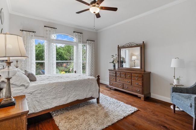 Primary bedroom has lots of natural light, view of pool, and motorized shades for sleeping comfort | Image 21