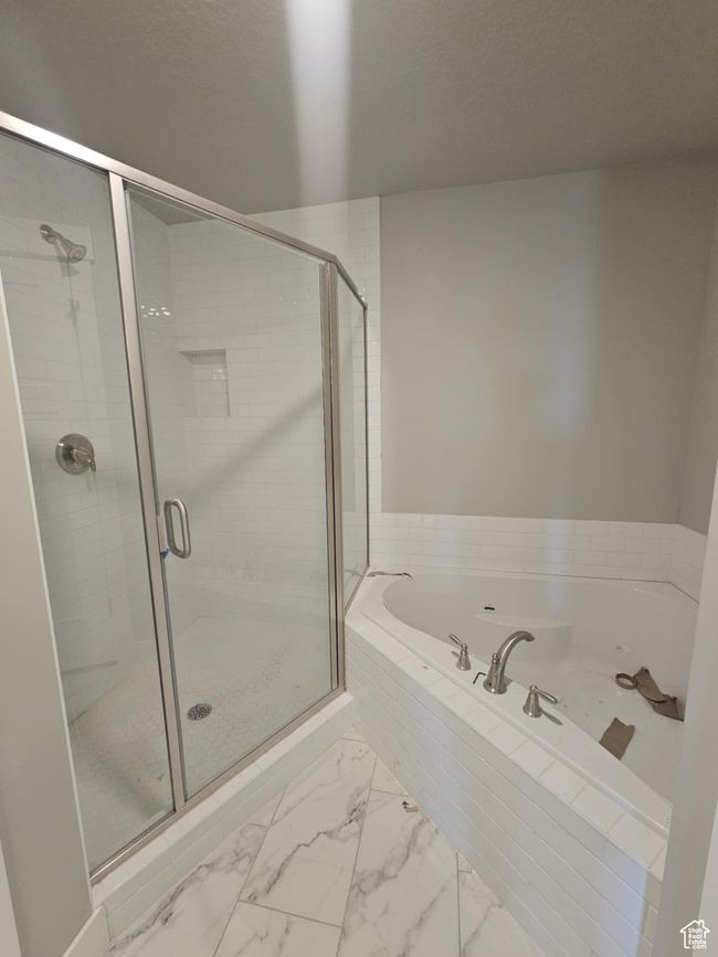 Full bath featuring a bath, a stall shower, and marble finish floors | Image 6
