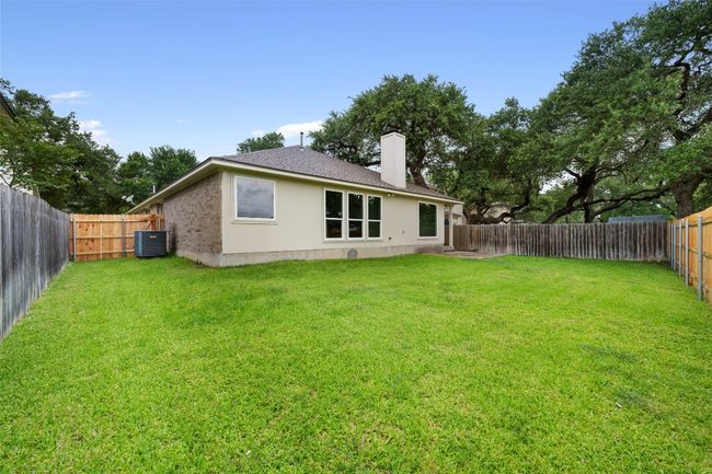 Back of property with a chimney, roof with shingles, a fenced backyard, and stucco siding | Image 37