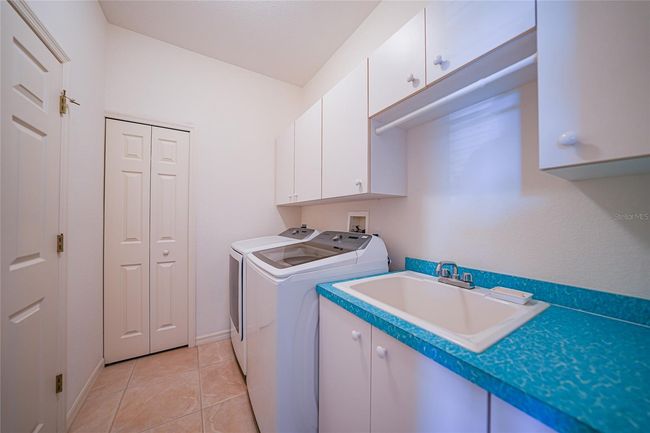 LAUNDRY ROOM WITH OVERHEAD CABINETS AND TWO CLOSETS | Image 42