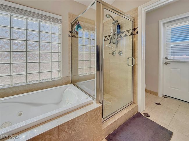 Full bath featuring a shower stall, a tub with jets, and a healthy amount of sunlight | Image 28