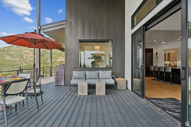 Wooden terrace featuring an outdoor hangout area and a sink | Image 49