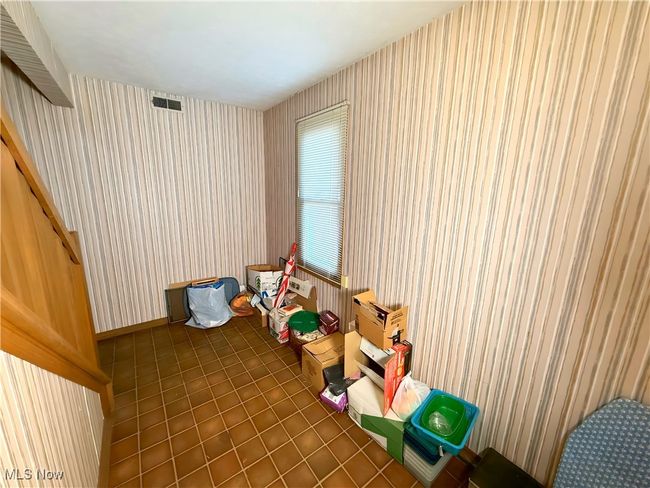 Game room with wallpapered walls and tile patterned flooring | Image 19