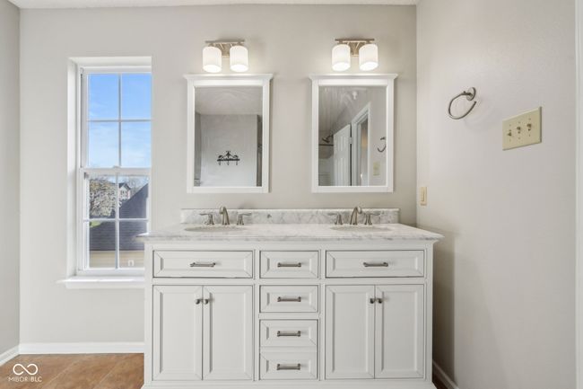 bathroom featuring double vanity and baseboards | Image 42