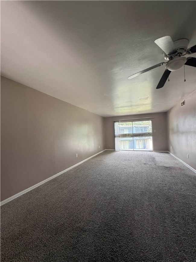 Unfurnished room featuring carpet flooring and a ceiling fan | Image 5